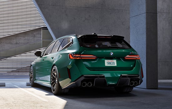 Green BMW M5 Touring parked in garage. | BMW of Devon in Devon PA