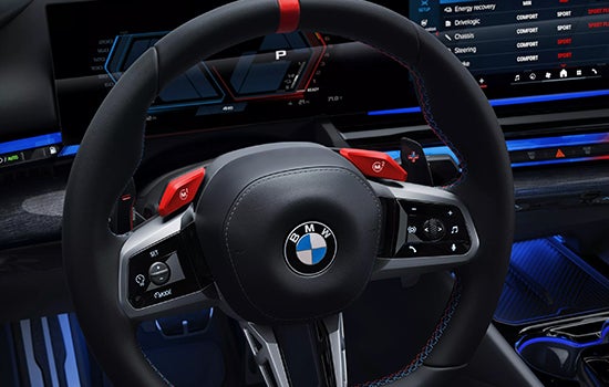 Close-up view of BMW M5 Touring steering wheel. | BMW of Devon in Devon PA