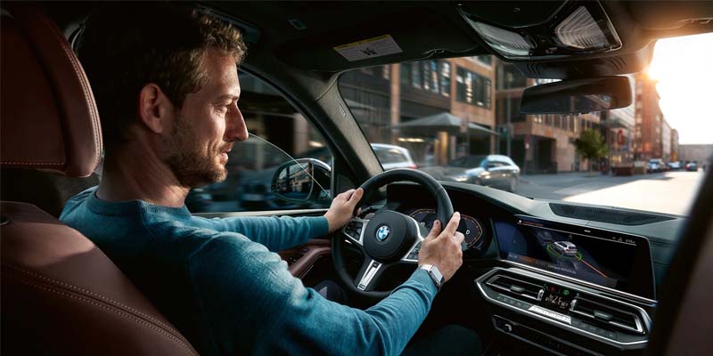 2023 X5 PHEV driving along a country road.